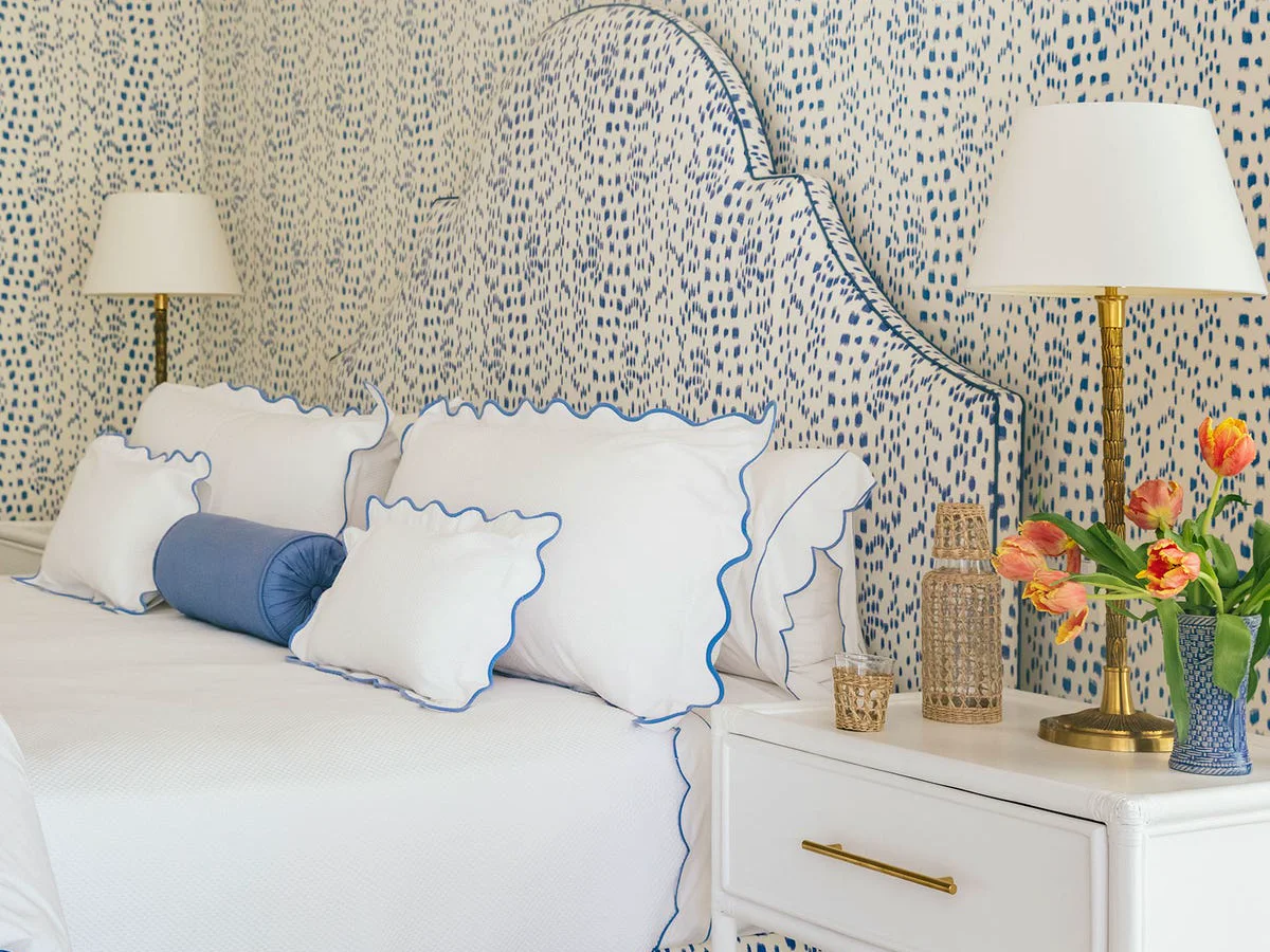 Bright bedroom with patterned wallpaper and blue details
